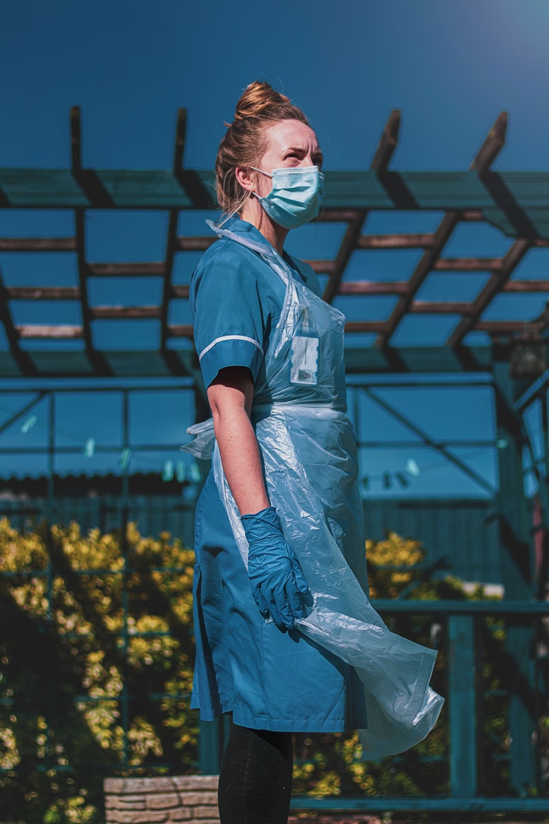 woman in blue and white polo shirt standing on yellow flower field during daytime