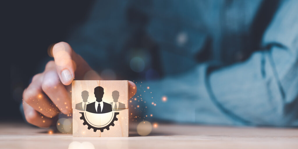 Businessman holding a wooden block ,team business success concept ,cooperation and support colleagues,brainstorming,corporate teamwork ,Successful business team ,Building a team to work together